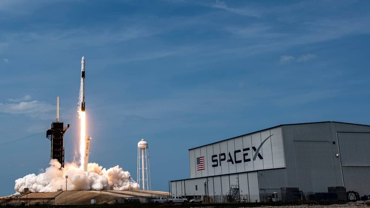 SpaceX Falcon 9 rocket launching into space with reusable booster landing technology.